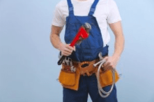 A repair man wearing blue overalls and a tan toolbelt0