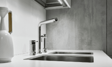 Shiny silver faucet in modern grey kitchen