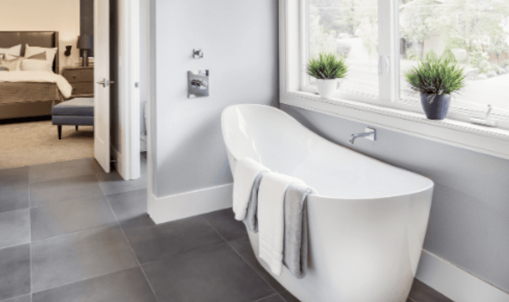 White tub in bright grey bathroom